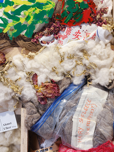detail  showing dried flowers, wool, old rags, brown yarn, oil painting, dried rose leaves