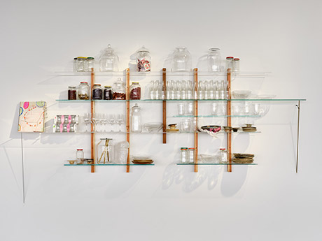 floating glass shelf with wood support holding tableware and glassware and bottles
